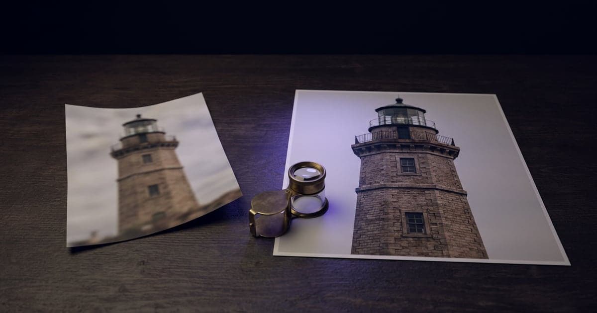 A small blurry photo next to the same photo printed large and sharp on a table.