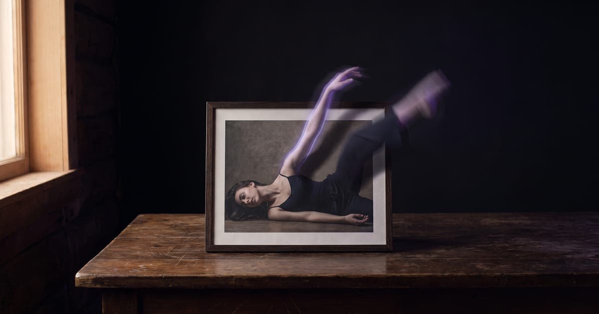 A printed photograph on a table whose subject seems to step out of the frame in motion blur.