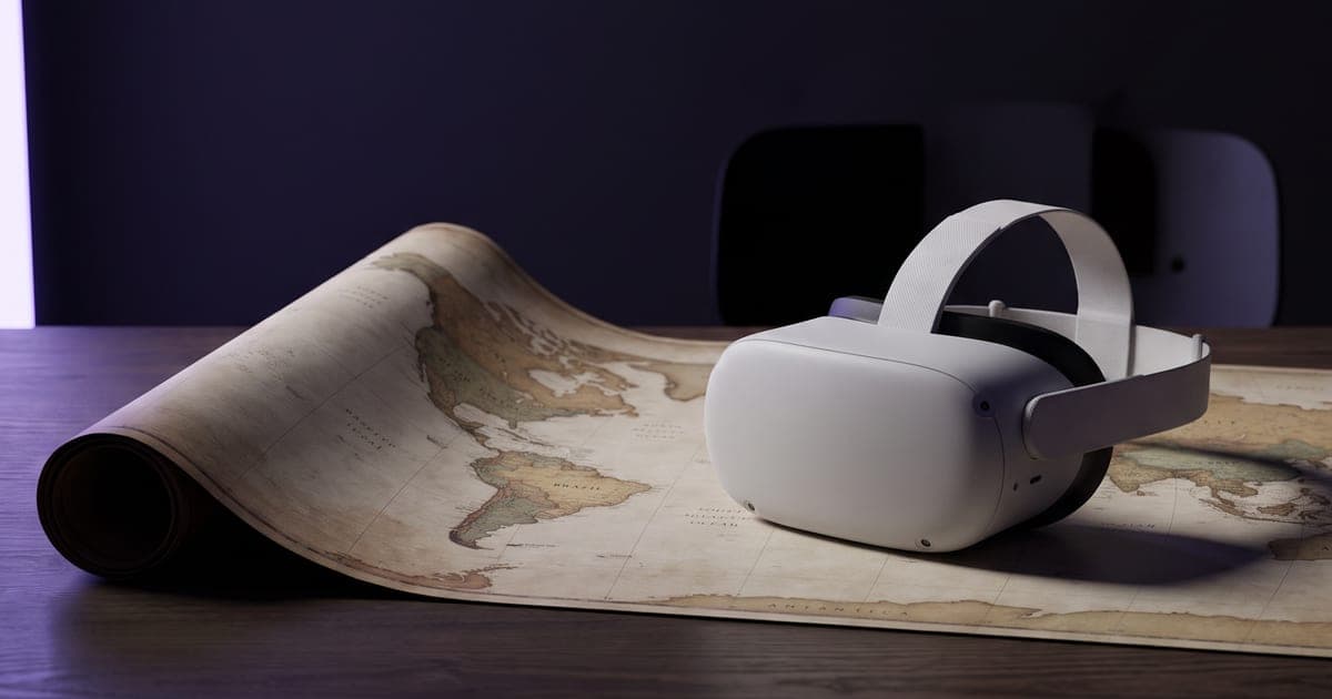 A virtual reality headset resting on a desk beside a printed world map.