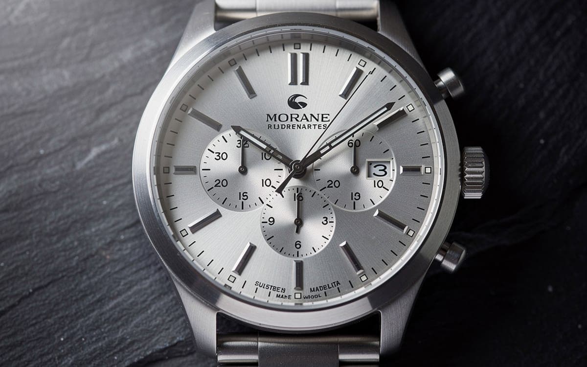 A close product shot of a watch face, with fine metal texture and sharp detail.