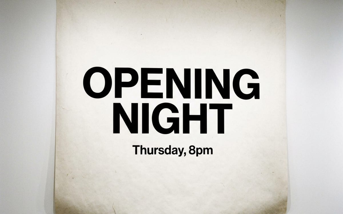 A gallery wall with a printed poster that reads OPENING NIGHT in clean type.